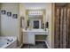 Bathroom featuring a vanity with a sink, a large mirror, and a bathtub with a shower curtain at 1047 Taso Trl, Acworth, GA 30101