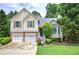 Charming two-story home with a two-car garage, well-manicured lawn and lush landscaping at 1047 Taso Trl, Acworth, GA 30101