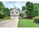 Traditional two-story home with a well-manicured lawn and a two car garage in a suburban setting at 1047 Taso Trl, Acworth, GA 30101