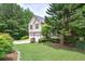 Traditional two-story home with a well-manicured lawn and a two car garage in a suburban setting at 1047 Taso Trl, Acworth, GA 30101