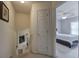 The hallway features neutral colored walls and carpet and leads to a bedroom with a gray color scheme at 1047 Taso Trl, Acworth, GA 30101