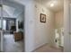 The hallway has neutral walls and carpet with a view into the living room and a bedroom beyond at 1047 Taso Trl, Acworth, GA 30101