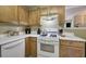 Efficient kitchen offering ample countertop space, wood cabinets and white appliances at 1047 Taso Trl, Acworth, GA 30101