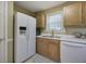 Functional kitchen featuring white appliances, wood cabinets and a stainless steel sink at 1047 Taso Trl, Acworth, GA 30101