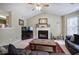Cozy living room features a fireplace and seamlessly connects to the dining area and kitchen at 1047 Taso Trl, Acworth, GA 30101