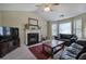 Spacious living room with a fireplace, large windows and comfortable seating area at 1047 Taso Trl, Acworth, GA 30101