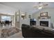 Open-concept living room features a fireplace, vaulted ceiling and view into the dining area at 1047 Taso Trl, Acworth, GA 30101