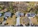 Aerial view of home with long driveway, surrounded by mature trees and well-manicured lawns at 1312 Brandl Dr, Marietta, GA 30008