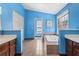 Bright bathroom featuring a large soaking tub, double vanity with dark wood cabinets, and neutral tile flooring at 1312 Brandl Dr, Marietta, GA 30008