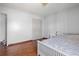 Bedroom features hardwood floors, a white bed with patterned bedding, and a closet with white doors at 1312 Brandl Dr, Marietta, GA 30008