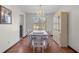 Elegant dining room with a chandelier, wood floors, and a view of the wooded backyard at 1312 Brandl Dr, Marietta, GA 30008
