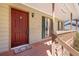 Covered front porch featuring a storm door, and views of the lawn and landscaping at 1312 Brandl Dr, Marietta, GA 30008