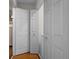 Hallway with three doors, one leading to a laundry room and two closet doors at 1312 Brandl Dr, Marietta, GA 30008