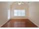Bedroom features high ceilings, wood floors, and a door with window to exterior at 223 Glens Loop, Woodstock, GA 30188