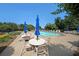 Community pool with plenty of seating, umbrellas and lush landscaping in a beautiful setting at 223 Glens Loop, Woodstock, GA 30188