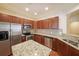 Open kitchen features granite countertops, stainless steel appliances, and wood cabinets at 223 Glens Loop, Woodstock, GA 30188