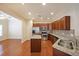 Modern kitchen with granite countertops, stainless steel appliances, wooden cabinets, and hardwood floors, great for cooking at 223 Glens Loop, Woodstock, GA 30188