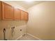 Practical laundry room with upper cabinets and easy access for household tasks at 223 Glens Loop, Woodstock, GA 30188