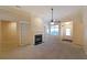 Spacious living area with a cozy fireplace, built-in bookshelves, and plenty of natural light from the nearby window at 223 Glens Loop, Woodstock, GA 30188
