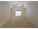 Spacious main bedroom with tray ceiling, fan, and large window letting in lots of natural light at 223 Glens Loop, Woodstock, GA 30188