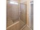 Tiled shower with glass door and built-in seat at 223 Glens Loop, Woodstock, GA 30188