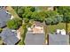 Aerial shot of a backyard with a stone patio, garden beds, mature landscaping, and surrounding trees at 2372 Oberon Se Walk, Smyrna, GA 30080