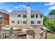 Large backyard with a stone patio, garden beds, and lush landscaping at 2372 Oberon Se Walk, Smyrna, GA 30080