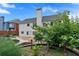 Spacious backyard featuring a stone patio, mature trees, and meticulously maintained garden beds at 2372 Oberon Se Walk, Smyrna, GA 30080