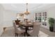 Elegant dining room with a chandelier, tray ceiling, and large windows, perfect for formal gatherings at 2372 Oberon Se Walk, Smyrna, GA 30080