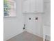 Practical laundry room with cabinets, a window, and laundry sink at 2372 Oberon Se Walk, Smyrna, GA 30080