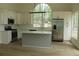 Modern kitchen features a center island, stainless steel appliances, and plenty of natural light at 4220 Glad Morning Dr, College Park, GA 30349