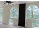 Bright, open living room featuring arched windows, wood floors, and a sleek, modern fireplace at 4220 Glad Morning Dr, College Park, GA 30349