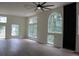Spacious living room with light wood floors, lots of light, and stylish black fireplace at 4220 Glad Morning Dr, College Park, GA 30349