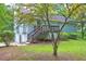 View of back exterior of home with raised deck and partial basement at 476 Cody Ln, Douglasville, GA 30134