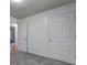 Neutral bedroom featuring gray carpet, white walls, and a closet with bright light filtering in from an open door at 476 Cody Ln, Douglasville, GA 30134