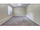 Neutral carpeted room with natural light from a window, light walls, and baseboard trim detail at 476 Cody Ln, Douglasville, GA 30134