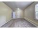 Spacious bedroom featuring gray carpet, white walls, and windows with blinds for privacy at 476 Cody Ln, Douglasville, GA 30134