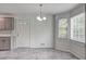 Dining area with three windows providing natural light, chandelier, and kitchen access at 476 Cody Ln, Douglasville, GA 30134