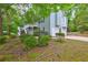 Exterior shot of home showing a three car garage, deck, and landscaping at 476 Cody Ln, Douglasville, GA 30134