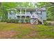 Charming front exterior with covered porch and well-maintained landscaping at 476 Cody Ln, Douglasville, GA 30134