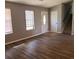 Inviting living room featuring new flooring, natural light, and access to the staircase at 5389 Martins Crossing Rd, Stone Mountain, GA 30088