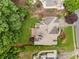 A bird's eye view showcases a beautiful home with a manicured lawn and garden, as well as a large deck at 2026 Cresthaven Walk, Woodstock, GA 30189