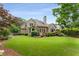 Spacious, well-maintained backyard with lush lawn, landscaping, and a charming outdoor deck area at 2026 Cresthaven Walk, Woodstock, GA 30189
