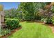 Expansive, well-manicured backyard featuring lush green grass, mature trees, and perimeter landscaping, perfect for outdoor activities at 2026 Cresthaven Walk, Woodstock, GA 30189