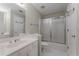 Well-lit bathroom with white vanity, toilet, shower/tub, and sliding glass doors at 2026 Cresthaven Walk, Woodstock, GA 30189
