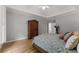 Comfortable bedroom with wood floors, vaulted ceiling, and neutral color scheme at 2026 Cresthaven Walk, Woodstock, GA 30189