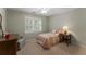 Cozy bedroom featuring a bed, side table, and chair near the window at 2026 Cresthaven Walk, Woodstock, GA 30189