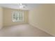 Bright bedroom with a neutral color palette, carpet flooring, and plantation shutters on the window at 2026 Cresthaven Walk, Woodstock, GA 30189