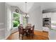 Bright breakfast nook features wood floors and charming chandelier lighting at 2026 Cresthaven Walk, Woodstock, GA 30189