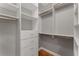 Walk-in closet offers custom shelving, drawers, and ample storage space at 2026 Cresthaven Walk, Woodstock, GA 30189